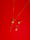 Golden ball pendant set with earring